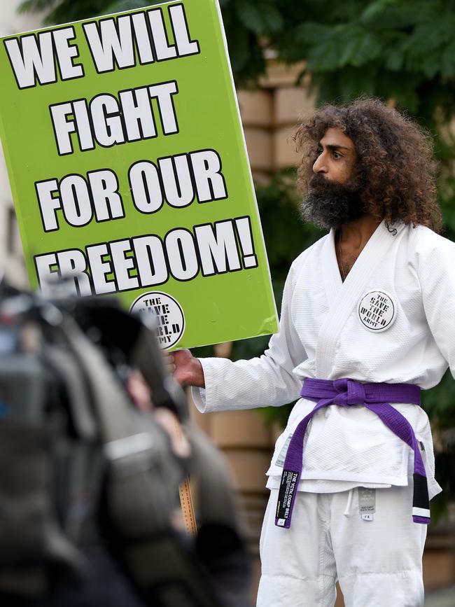 A protester fights to get his message across yesterday in Sydney. Picture: AAP