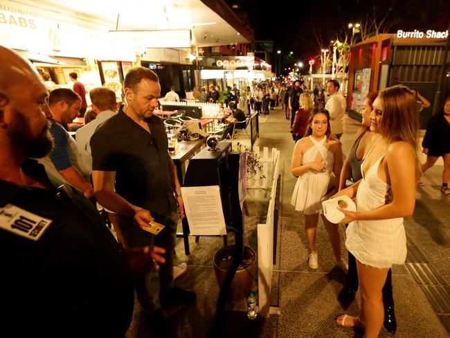 IDs are scanned at the entrance to a Fortitude Valley nightclub. Picture: Mark Calleja/AAP