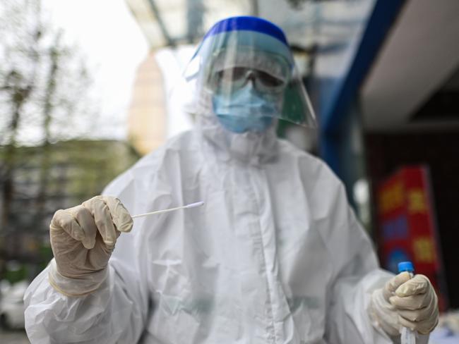 A medical worker gets a swab sample for a COVID-19 test in Wuhan, in China's central Hubei province. Picture: AFP