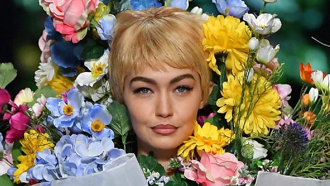 Model Gigi Hadid presents a creation for fashion house Moschino during the Women's Spring/Summer 2018 fashion shows in Milan, on September 21, 2017.  / AFP PHOTO / Marco BERTORELLO