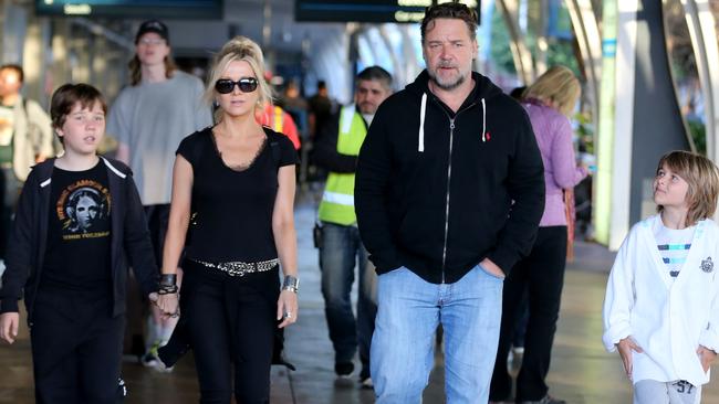 Russell Crow appears at Sydney Airport arrivals with Danielle Spencer and thier kids Charles and Tennyson.