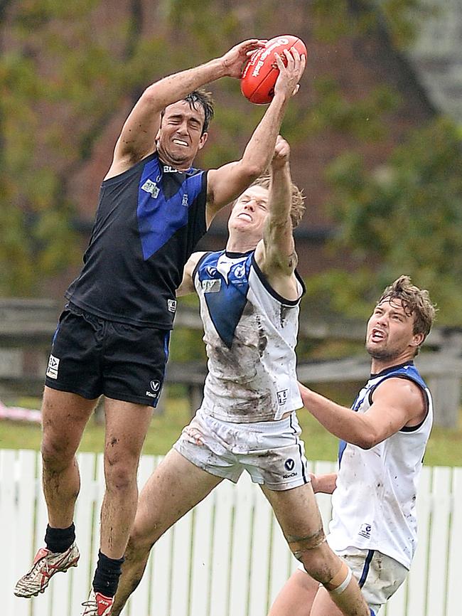 Huw Lacey flies for a mark for University Blacks. Picture: David Smith