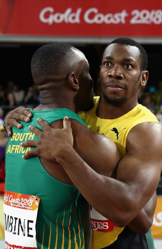 A disappointed Blake embracing Simbine after the race.