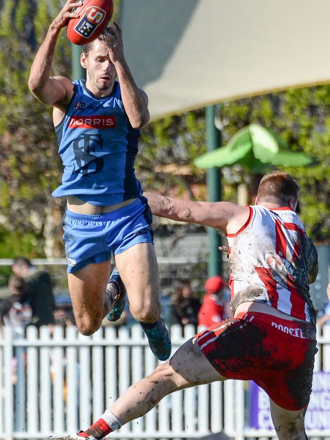 Sturt’s Daniel Fahey-Sparks flies high over North Adelaide’s Mitch Harvey at Unley Oval on Saturday. Picture: Brenton Edwards