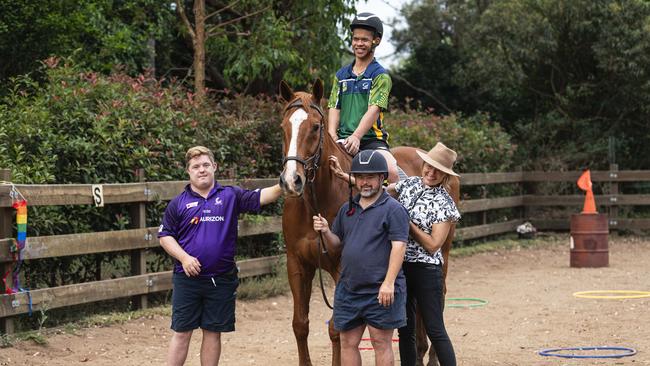 Para dressage competitor Brooke Neville working with Off the Track thoroughbred George and new horse lovers Man (in the saddle), Jacob (left) and Josh. Picture: Kevin Farmer