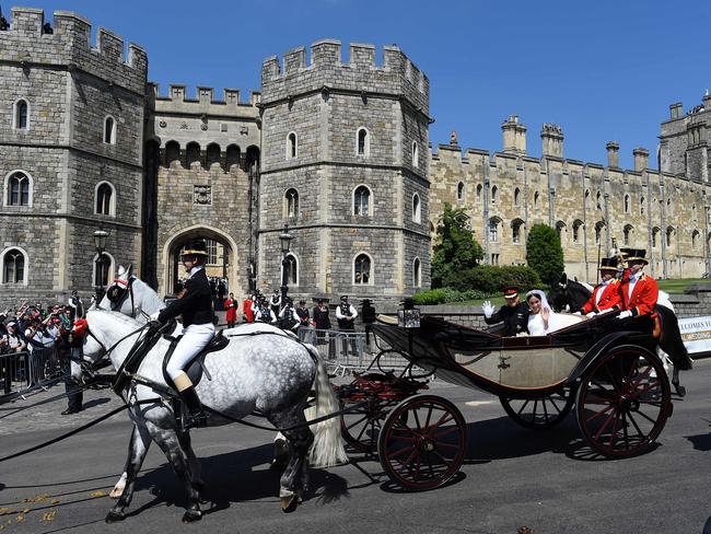 Britain's Prince Harry, Duke of Sussex and his wife Meghan, Duchess of Sussex wave from the Ascot Landau Carriage. Picture: AFP