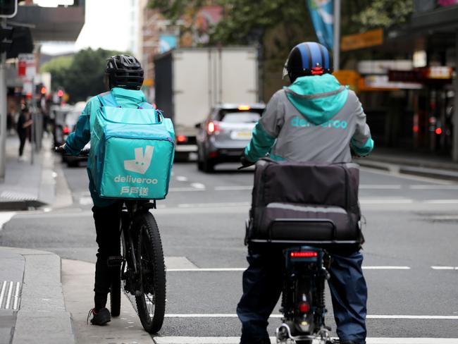 SYDNEY, AUSTRALIA - NewsWire Photos FEBRUARY 25: Food delivery riders pictured in the Sydney CBD. Food delivery and rideshare workers have compared their conditions to"slavery“ as they demand rights to a minimum wage. Picture: NCA NewsWire / Damian Shaw