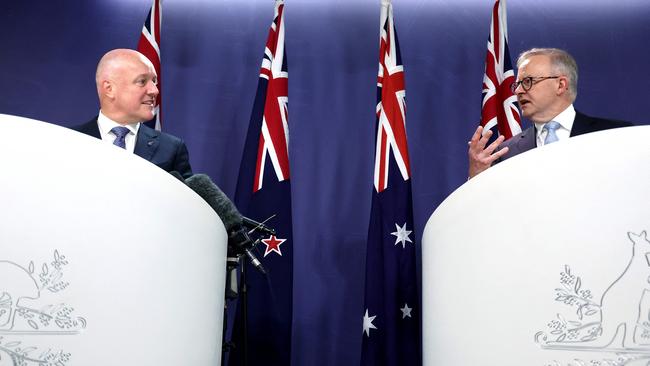 New Zealand's Prime Minister Christopher Luxon (L) reacts as he listens to Australia's Prime Minister Anthony Albanese speak.