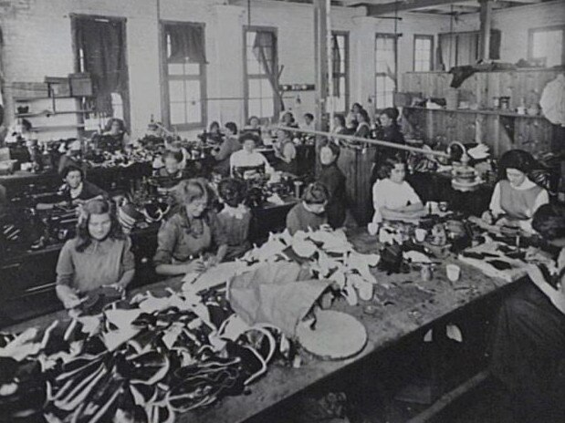 Workers manufacturing boots in the old factory