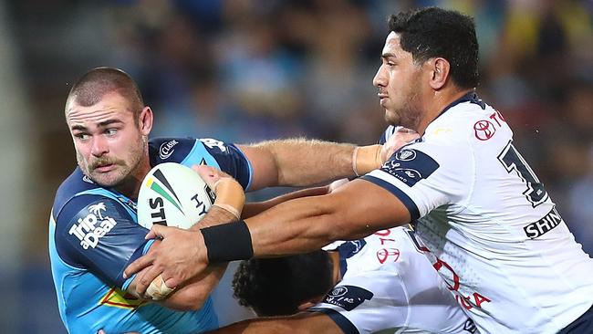 Keegan Hipgrave of the Titans is tackled during the round 25 NRL match between the Gold Coast Titans and the North Queensland Cowboys at Cbus Super Stadium. Photo: Getty Images