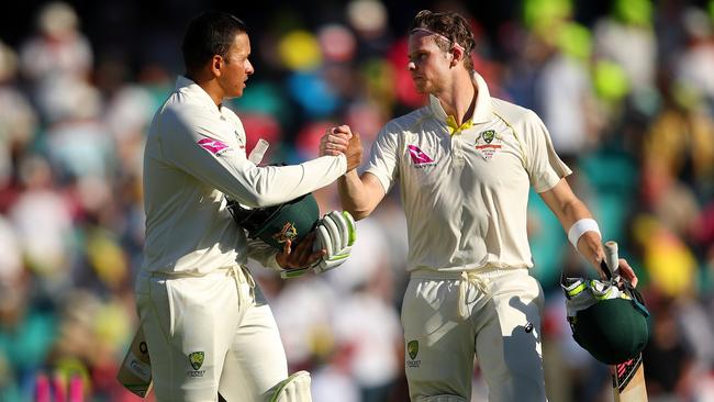 Usman Khawaja (left) and Steve Smith leave the field following the day’s play on Friday.
