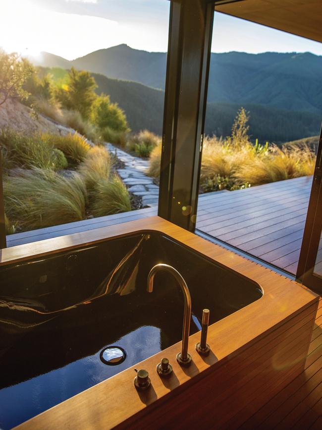 The timber-clad bath at Falcon Brae overlooks the valley where the Motueka River flows. Picture: Camilla Rutherford