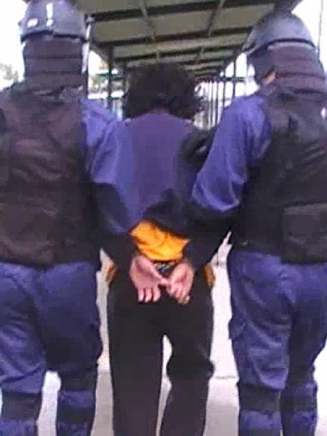 Staff in safety gear move a detainee at a juvenile correctional centre. Picture: Supplied