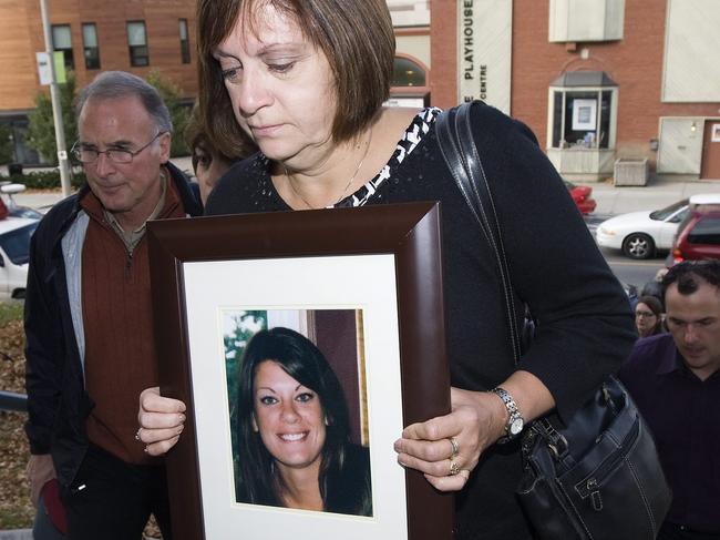 Roxanne Lloyd arrives at court carrying a photo of her slain daughter. Picture: Nathan Denette