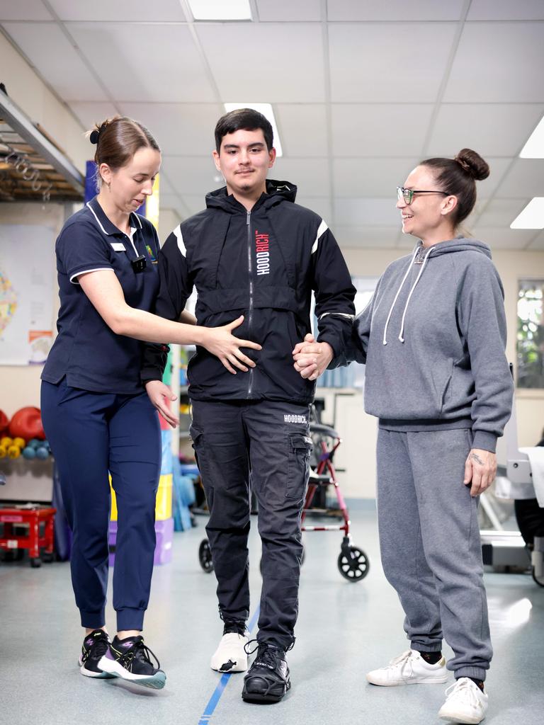 L to R, Meg Ingram, Physiotherapist, Paxton 17yrs, Natalie Zocaro (mum). Picture: Steve Pohlner/Courier Mail