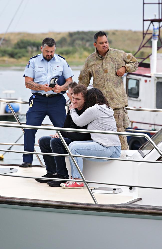 Relatives of the victims return from giving blessing to the military personal retrieving the bodies off White Island. Picture: Adam Yip