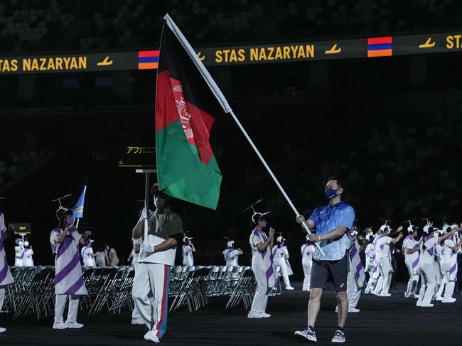 The flag of Afghanistan is carried out at the opening ceremony for the Tokyo 2020 Paralympic Games at the Olympic Stadium in Tokyo on August 24, 2021. (Photo by YASUYOSHI CHIBA / AFP)