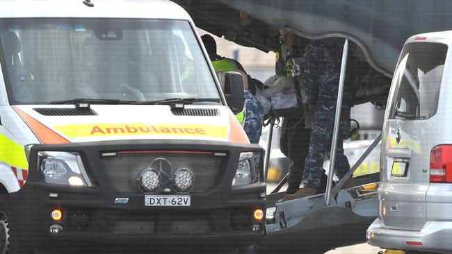 A survivor of the fatal Whaakaari Volcanic eruption in New Zealand is removed on a stretcher from a RAAF C-130 Hercules at Sydney Airport in Sydney. Picture: AAP