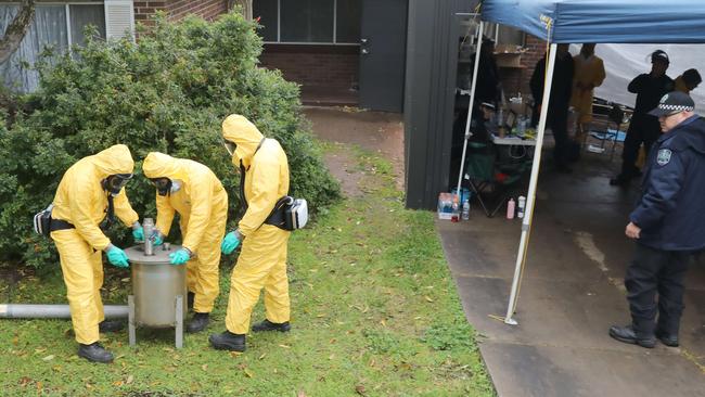 Detectives remove sophisticated drug production equipment from the clandestine drug laboratory. Picture: Dean Martin