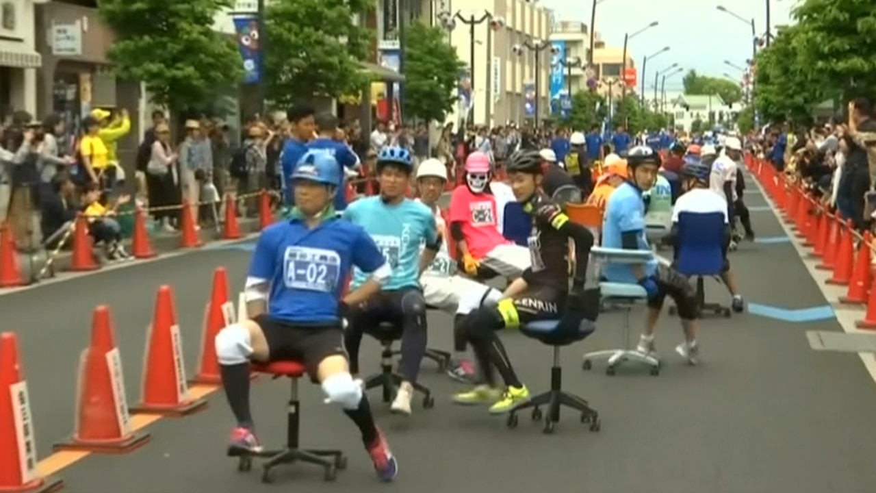 Japanese competitors race office chairs to win rice | Daily Telegraph