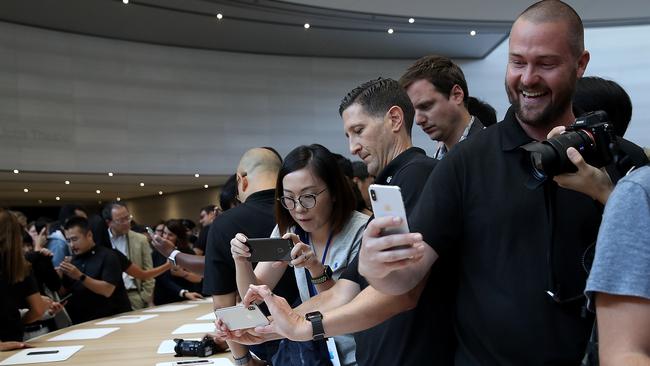 Attendees look at Apple’s new smartphones during their launch in Apple Park on September 13. Picture: Justin Sullivan/Getty Images/AFP