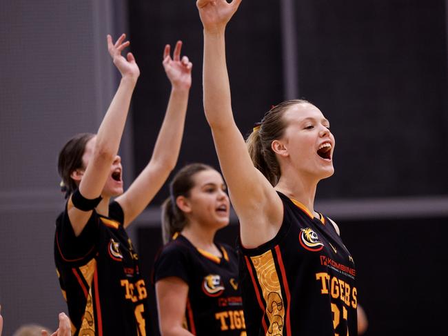 Melbourne Tigers players celebrate on the sidelines during the Under-18 Club Championships. Picture: Michael Farnell