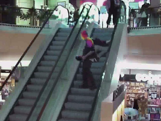 After an argument he pushes the staff member down the escalator.