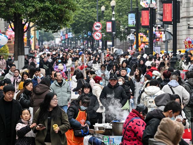 People walk in Wuhan, in China’s central Hubei province. Picture: AFP