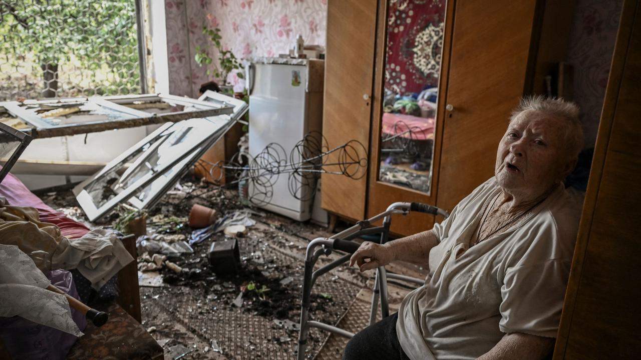 A woman sits inside her damaged home after a missile strike in Soledar. Picture: AFP