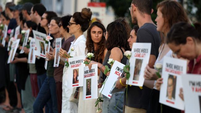 People carry placards bearing pictures of missing persons as they protest for the release of Israelis held hostage by Hamas militants in the Gaza Strip, outside the Ministry of Defence in Tel Aviv. Picture: AFP