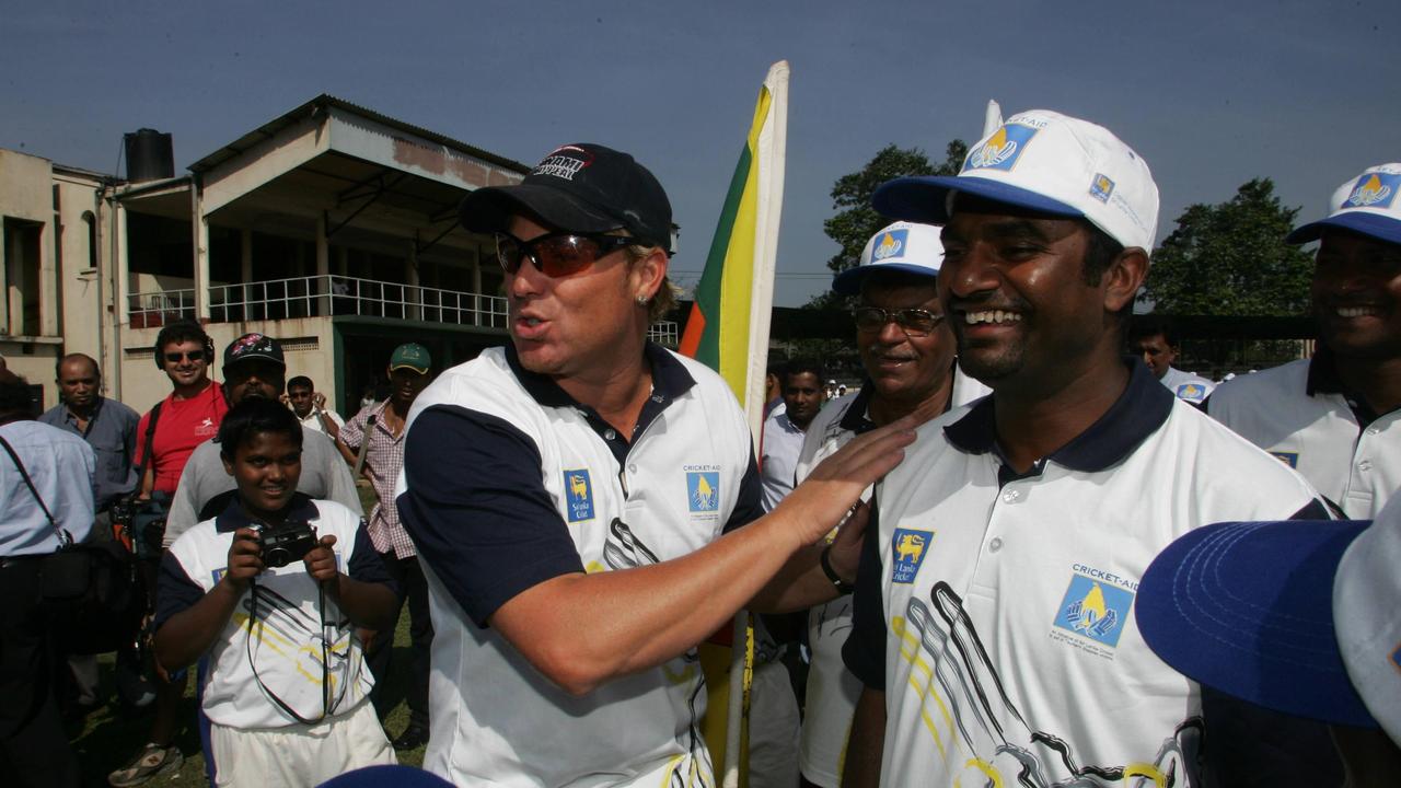 Warne and Murali hold a cricket clinic for 200 school kids just outside Colombo in 2005.