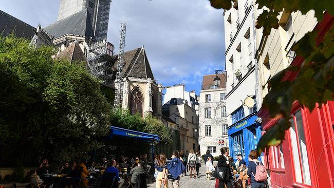 People on a street in the historic Marais district of Paris, France.