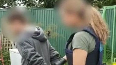 An Australian Federal Police officer arrests a 24-year-old man in Whalan after he allegedly shared child abuse material online. Picture: AFP