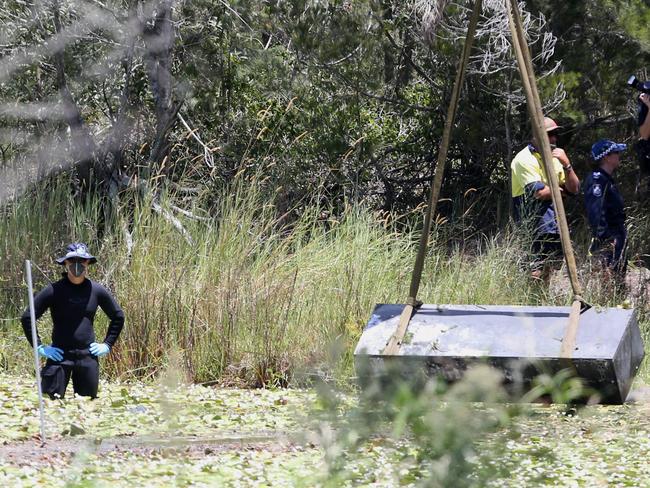 Toolbox murder -  Police retrieve a metal box from a dam near Srubby Creek in Kingston, double murder Logan.. Pic Jono Searle.