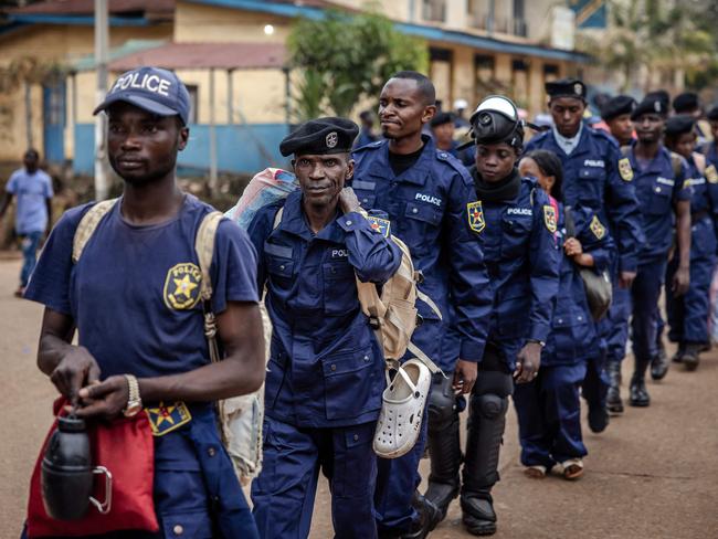 Congolese police officers line up for redeployment following an enrollment of civilians, police officers, and former members of the Armed Forces of the Democratic Republic of Congo (FARDC) who allegedly decided to join the M23 movement voluntarily in Bukavu on February 22, 2025. Congolese President Felix Tshisekedi is on a quest for support as war in the east rages, but has so far returned empty-handed from trips abroad while anxiety mounts at home. Tshisekedi recently visited Angola and attended a security conference in Munich without making a clear diplomatic breakthrough, after Rwanda-backed M23 fighters seized control of two major eastern cities in the Democratic Republic of Congo. (Photo by Luis TATO / AFP)