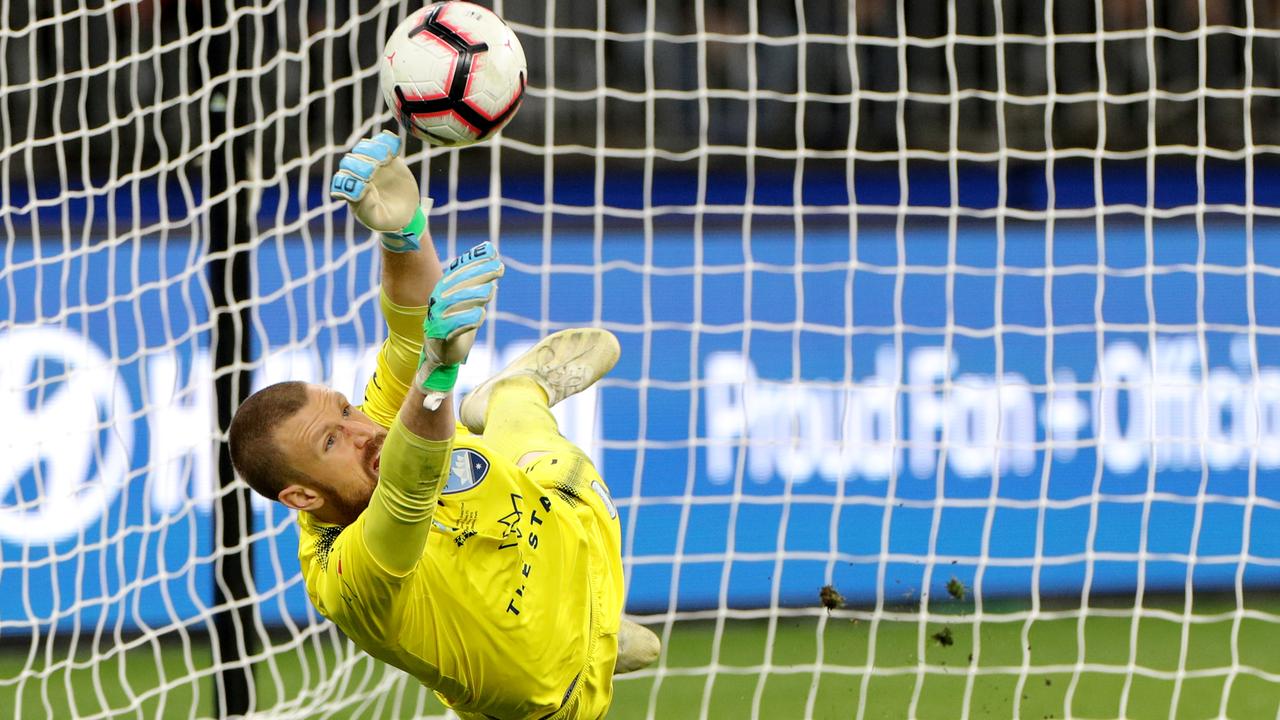 Andrew Redmayne of Sydney saves a penalty kick by Andy Keogh