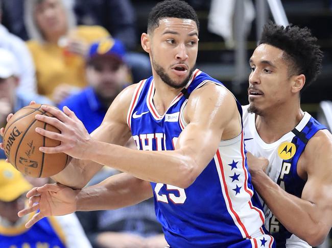 INDIANAPOLIS, INDIANA - JANUARY 13: Ben Simmons #25 of the Philadelphia 76ers dribbles the ball while defended by Malcolm Brogdon #7 of the Indiana Pacers at Bankers Life Fieldhouse on January 13, 2020 in Indianapolis, Indiana. NOTE TO USER: User expressly acknowledges and agrees that, by downloading and or using this photograph, User is consenting to the terms and conditions of the Getty Images License Agreement.   Andy Lyons/Getty Images/AFP == FOR NEWSPAPERS, INTERNET, TELCOS & TELEVISION USE ONLY ==