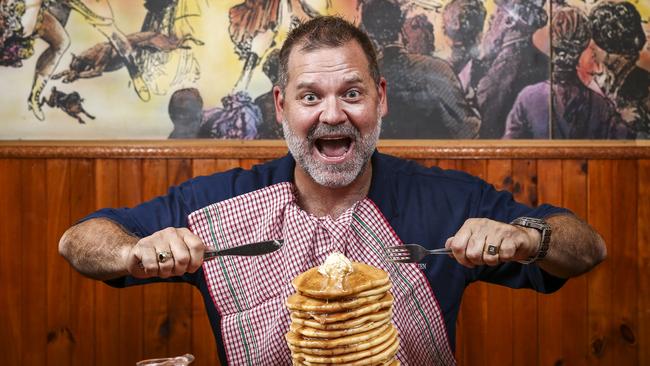 Proprietor Mark Sandgren tucks into a stack of pancakes, made to the original secret recipe. Picture: Mike Burton