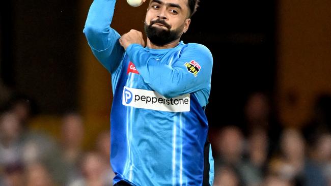 BRISBANE, AUSTRALIA - DECEMBER 23: Rashid Khan of the Strikers bowls during the Men's Big Bash League match between the Brisbane Heat and the Adelaide Strikers at The Gabba, on December 23, 2022, in Brisbane, Australia. (Photo by Bradley Kanaris/Getty Images)