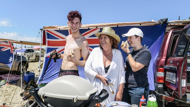 Sonic the dog, Jayden Nolan, Tina and Kayla Neilson enjoying a BBQ at Moana Beach for Australia Day, Moana, Australia. (Photo by Morgan Sette)