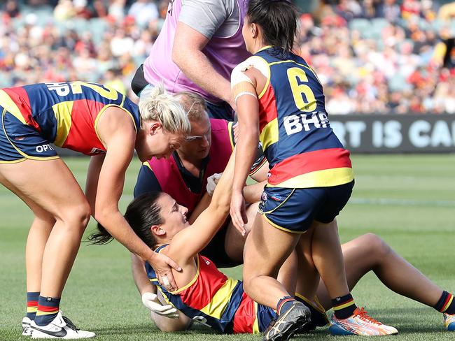 Angela Foley is helped up by teammates after tearing her ACL during the AFLW Grand Final. Picture: Getty Images