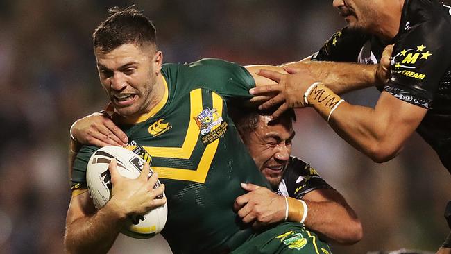 WOLLONGONG, AUSTRALIA - OCTOBER 25: James Tedesco of Australia is tackled during the International Rugby League Test Match between the Australian Kangaroos and the New Zealand Kiwis at WIN Stadium on October 25, 2019 in Wollongong, Australia. (Photo by Mark Metcalfe/Getty Images)