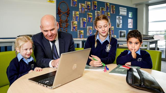 Catholic Education SA director Neil McGoran with students Violet, Maya and Willae at Dominican School, Semaphore. Picture: Mike Burton