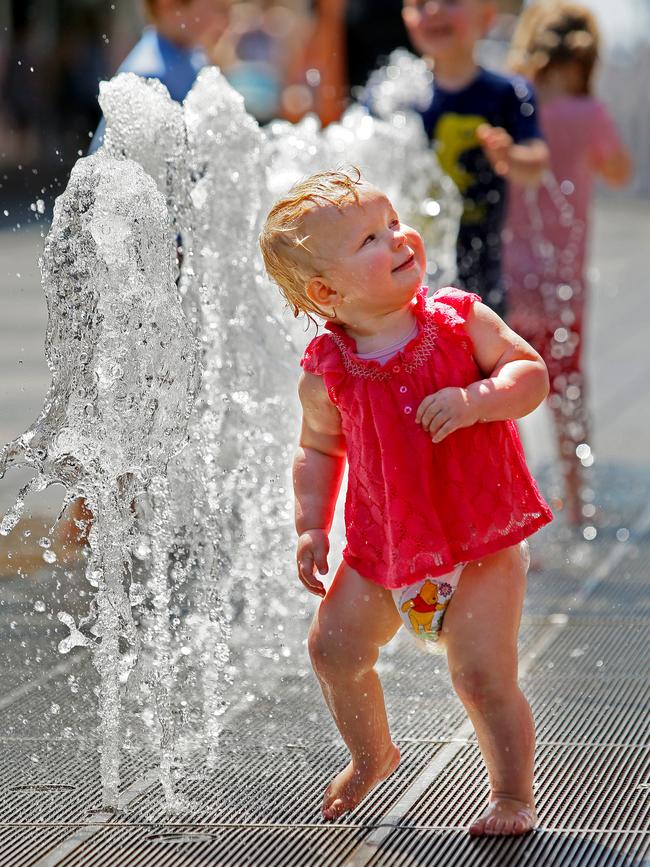 Zara Rogers, 18 months, cools off under a water fountain in The Corso during the Manly Jazz Festival in 2015. Picture: Troy Snook