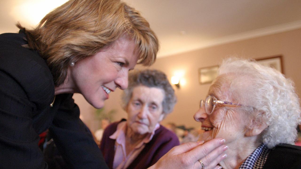 Bishop chats with nursing home resident Kitty Hollis, with Irene Gilbert in background, in 2004. Picture: Brad Wagner