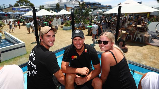 Lleyton Hewitt at the Mastercard Beach Club with fans Connon Thomson and Grace Cosbie. Picture: Chris Hyde