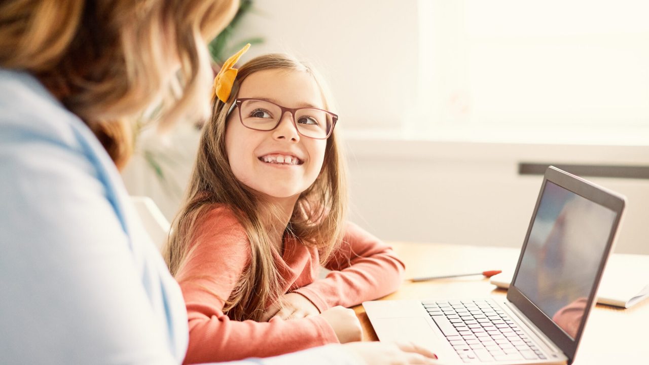 Mother and daughter Having fun with laptop at home