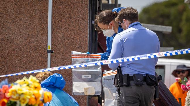 Detectives and forensics examine the area. Picture: Jason Edwards