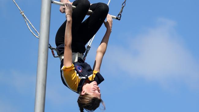 The Stunt Academy Obstacle Park in Nerang: Chloe Geneve tries her hand at the trapeze with Circus Arts. Picture by Scott Fletcher