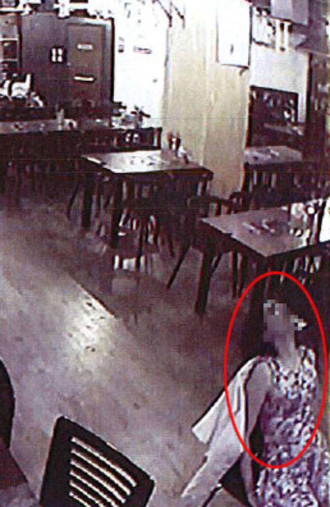 A woman, collapses backwards in a seat at the restaurant. Picture: AAP/Supplied by Liquor and Gaming
